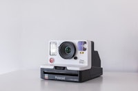 a white polaroid camera sitting on a table